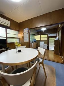 a dining room with a white table and chairs at Naoshima J-House in Naoshima