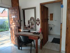 a bathroom with a vanity with a mirror and a sink at Lourette se Plek in Sannieshof +18 photos