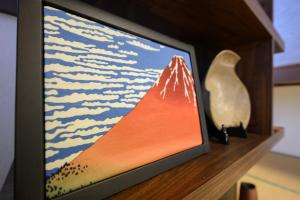 a television screen with a picture of a mountain at soleggiato suminoe in Osaka