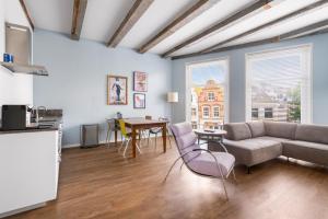 a living room with a couch and a table at Five Churches View apartments in Haarlem