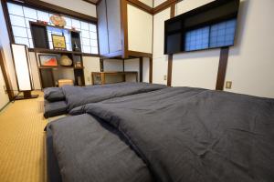 a bedroom with four beds in a room with windows at soleggiato suminoe in Osaka +20 photos