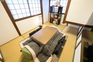 a room with a table and a bed in it at soleggiato suminoe in Osaka