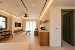 a kitchen and living room with a ceiling fan at LEOLIA Nautical Resort Kala Nera - Handwritten Collection in Volos