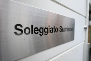 a sign on the side of a building at soleggiato suminoe in Osaka