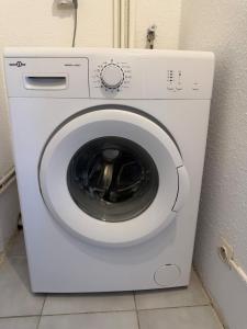 a white washing machine sitting in a room at Apartment - Beach - AC - Private parking in Saint-Cyprien-Plage