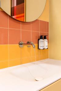 a bathroom sink with a faucet at Hotel Domburg4you in Domburg +61 photos