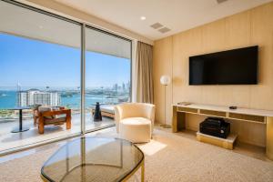 a living room with a tv and a large window at FIVE Palm Residence - Elegant Homes in Dubai