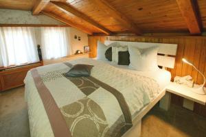 a bedroom with a large bed in a room with wooden ceilings at Chata Ostrov - Eiland v srdci Českého Švýcarska in Tisá +48 photos