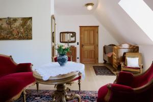 a living room with a vase of flowers on a table at Weingut Bleyweis in Kitzeck im Sausal