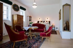 a bedroom with a table and chairs and a bed at Weingut Bleyweis in Kitzeck im Sausal