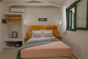 a bedroom with a large bed with a wooden headboard at THIRES Guesthouse in Vasilikos +83 photos