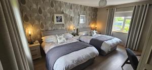 a bedroom with two beds and a window at Rowanville Lodge in Grange