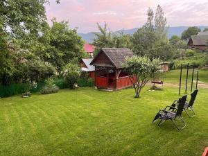 a yard with a gazebo and a bench in the grass at Затишний дім in Yaremche
