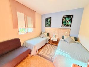 a living room with two beds and a couch at Villa Mansa in Pechina +28 photos