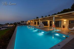 a swimming pool at night with blue lights at Villa Lamar Private Luxury Villa in Marathias +53 photos