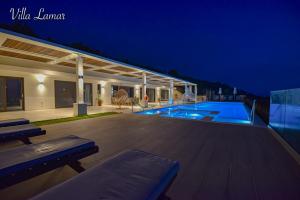 a house with a swimming pool at night at Villa Lamar Private Luxury Villa in Marathias