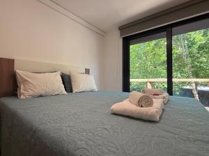 a bedroom with a large bed with a large window at Outeiro do Moinho - Rooms & Bungalows in Campo do Gerês +77 photos