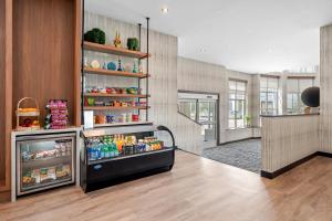 a room with a refrigerator filled with lots of drinks at Beacon Suites Hotel in Somerville