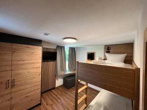 a small bedroom with a bed and wooden cabinets at Hotel Rad in Leutkirch im Allgäu