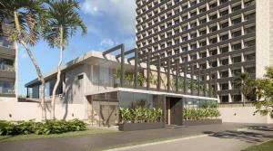 a building with a palm tree next to a tall building at Beach GAV Resorts in Salinópolis
