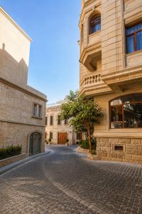 a cobblestone street in front of a building at The Destan Hotel and Terrace in Baku