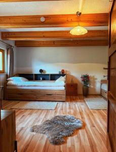 a bedroom with a bed and a rug on the floor at Das Försterhaus 41 in Aschau