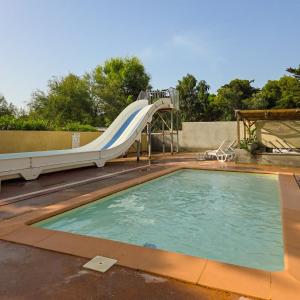 a swimming pool with a slide and a swimming pool at Cap du Roc in Port-la-Nouvelle
