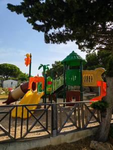 a playground with a slide in a park at Cap du Roc in Port-la-Nouvelle