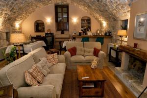 a living room with two couches and a fireplace at Archontiko Leontari in Leondari