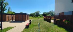 a park with benches and a fence and a building at Apartament Milicz in Milicz