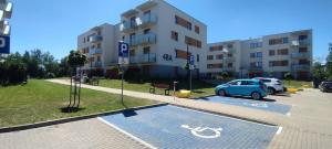 a car parked in a parking lot next to a building at Apartament Milicz in Milicz