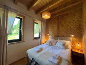 a bedroom with a bed in a room with a window at Chata Rosocha domek na wyłączność in Cisna