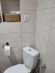 a bathroom with a toilet and a basket on the wall at BECEJŁY de LUX in Becejły +38 photos