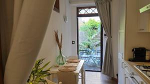 a kitchen with a table with two chairs and a window at The Nest & The Crest in Maratea