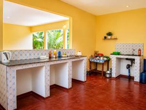 a kitchen with yellow walls and a counter top at Tumaini Bungalows in Nungwi +21 photos