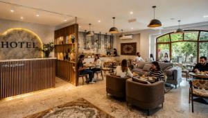 a group of people sitting in a hotel lobby at The Destan Hotel and Terrace in Baku