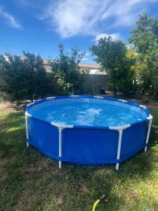 a large blue hot tub sitting in the grass at Aux Amelierets in Saint-Just