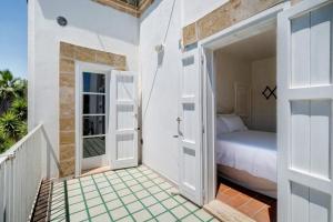 a bedroom with a bed and a door to a balcony at Villa La Cucchiara in Santa Caterina di Nardò