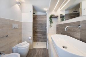 a bathroom with a tub and a toilet and a sink at Villa La Cucchiara in Santa Caterina di Nardò +31 photos