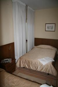 a small bedroom with a bed and a window at Gelindo Dei Magredi in Vivaro +26 photos