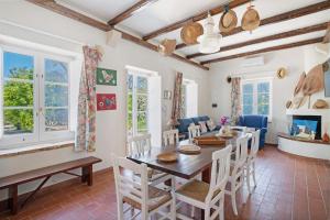 a dining room with a table and chairs at Villa La Cucchiara in Santa Caterina di Nardò