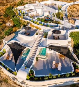 an aerial view of a villa with a swimming pool at Sun Angelos Oia - Luxury Cave Suites in Oia