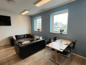 a living room with a couch and a table at Bodo Motel Norway in Bodø