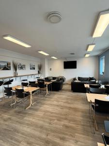 a conference room with tables and chairs and a couch at Bodo Motel Norway in Bodø