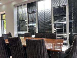 a conference room with a table and chairs and windows at Peaceful Garden Villa in Gabala +42 photos