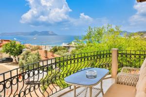 a balcony with a table and a view of the ocean at The Townhouse Apartment in Kaş
