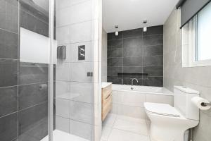 a bathroom with a toilet and a shower and a sink at Soundview in Lerwick +5 photos