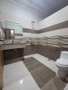 a bathroom with a toilet and a sink at INTOWN Hotel in Islamabad