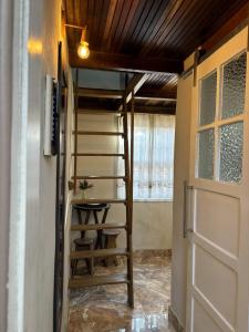 a room with a ladder next to a door at Chalé Diamante c /AR in Volta Redonda