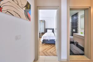 a view of a bedroom with a bed and a bathroom at The Townhouse Apartment in Kaş